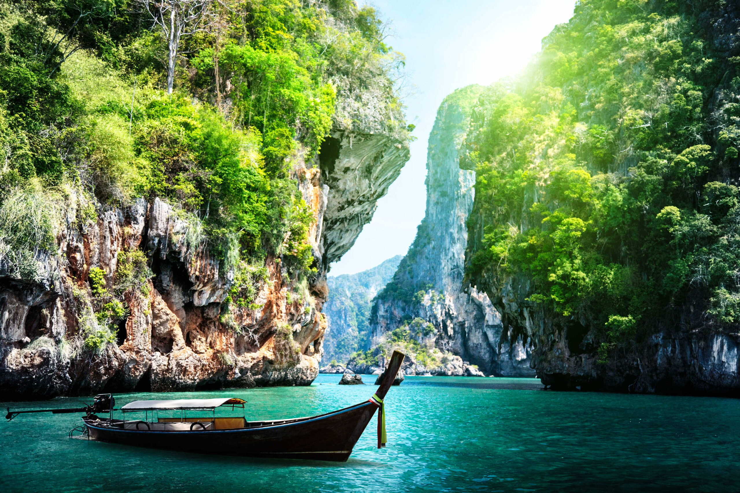 long boat and rocks on railay beach in Krabi Thailand